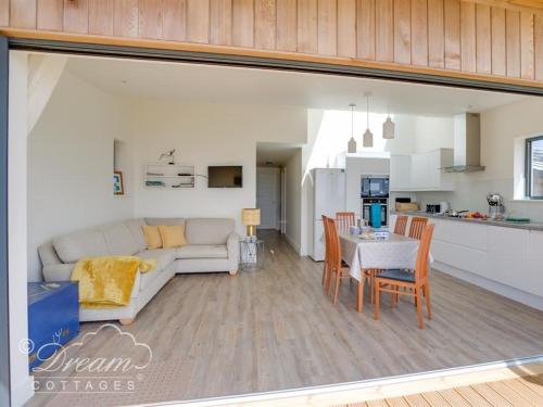 a living room with a white couch and a table at The Wave in West Bay