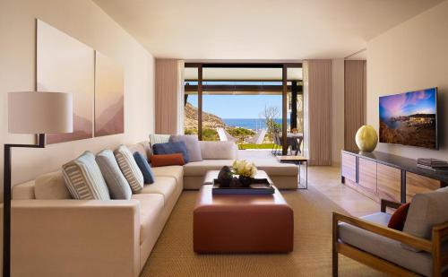 a living room with a couch and a table at Montage Los Cabos in Cabo San Lucas