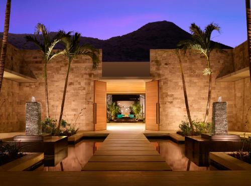 a lobby of a house with palm trees at Montage Los Cabos in Cabo San Lucas