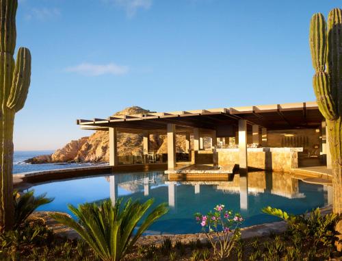 a house with a swimming pool with a view of the ocean at Montage Los Cabos in Cabo San Lucas