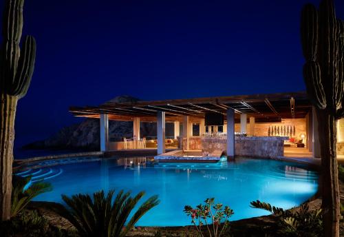 a villa with a swimming pool at night at Montage Los Cabos in Cabo San Lucas