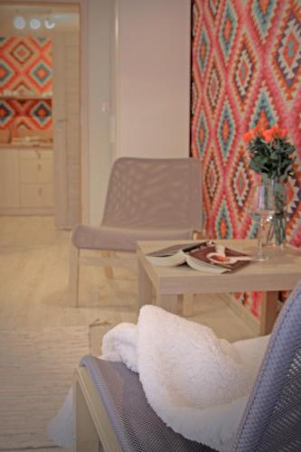 a living room with a table and a chair at Pod Wodospadem in Szczyrk