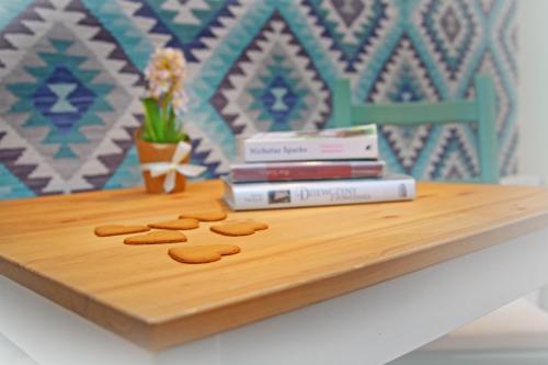 a wooden table with cookies and books on it at Pod Wodospadem in Szczyrk