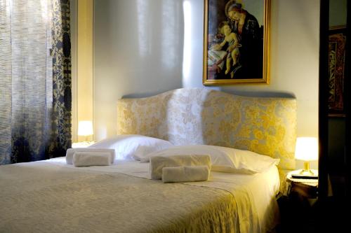 a bedroom with a bed with two pillows on it at Al Tuscany in Lucca