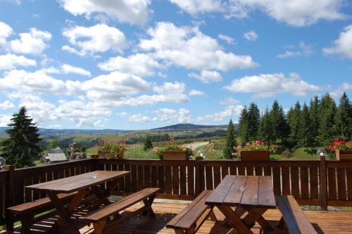 a picnic table on a deck with a view at Cabana Moţilor in Mărişel