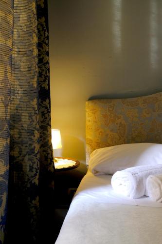 a hotel room with a bed with towels on it at Al Tuscany in Lucca