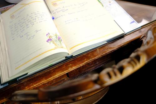 an open book on a table with a pen at Al Tuscany in Lucca
