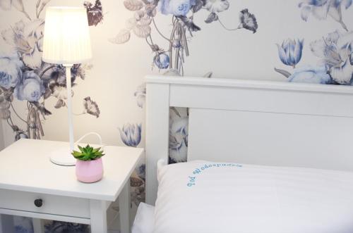 a bedroom with a bed and a table with a lamp at Pod Wodospadem in Szczyrk