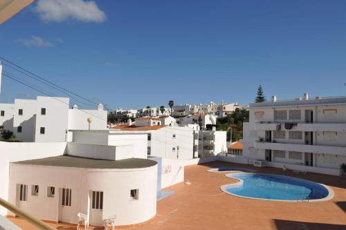 a view from the roof of a building with a swimming pool at Casa Franki - Stylish and large beach apartment in Algarve in Carvoeiro