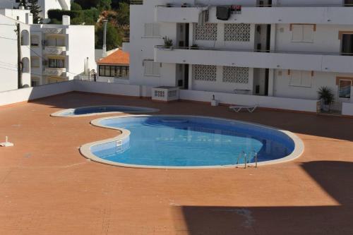 a swimming pool on the roof of a building at Casa Franki - Stylish and large beach apartment in Algarve in Carvoeiro