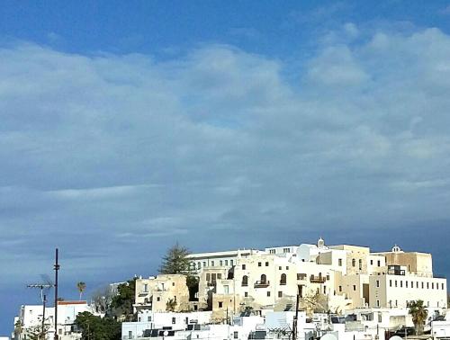 a large white building on top of a city at gatis house in Naxos Chora