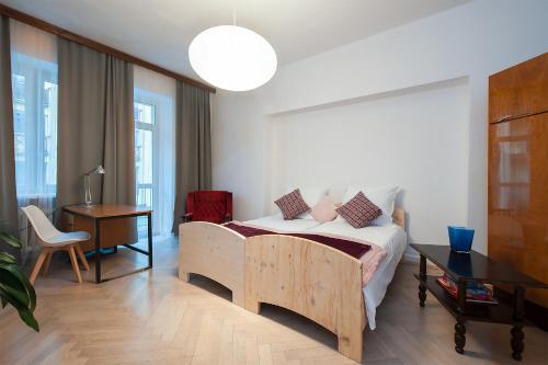 1 dormitorio con cama, escritorio y lámpara en 4CULTURE APART bezpłatny parking, en Łódź