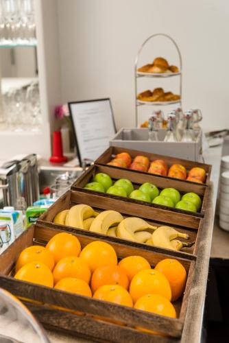 two trays of oranges and green apples and bananas at Dunalastair Hotel Suites in Kinloch Rannoch