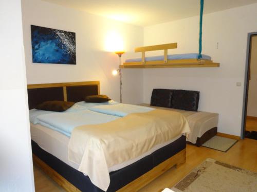 a bedroom with two beds and a shelf on the wall at Appartement Schwarzenbacher in Kaprun