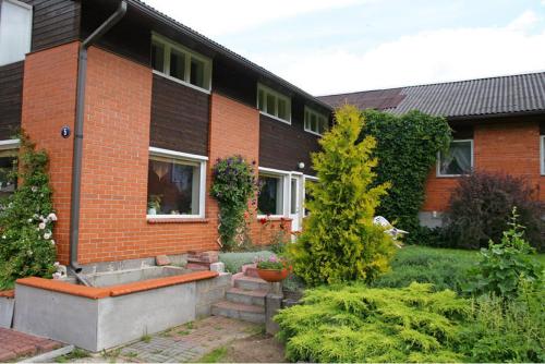 a brick house with a garden in front of it at Rähni Maja in Põlva