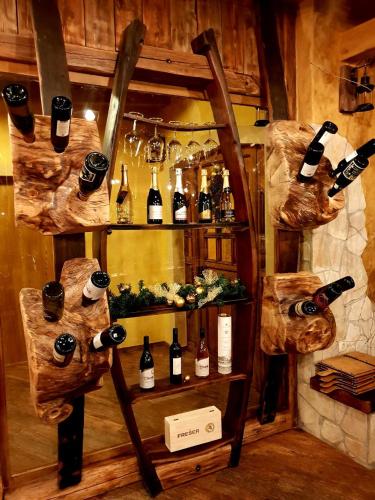 a room with a shelf with bottles of wine at Gorska Reka Guesthouse in Zreče