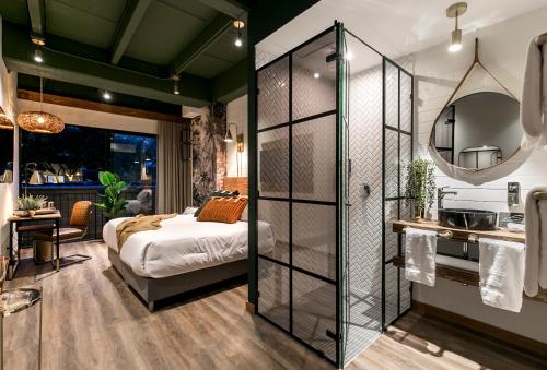 a bedroom with a bed and a glass wall at Celestino Boutique Hotel & Spa in Medellín