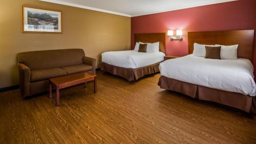 a hotel room with two beds and a chair at Best Western Bennington in Bennington