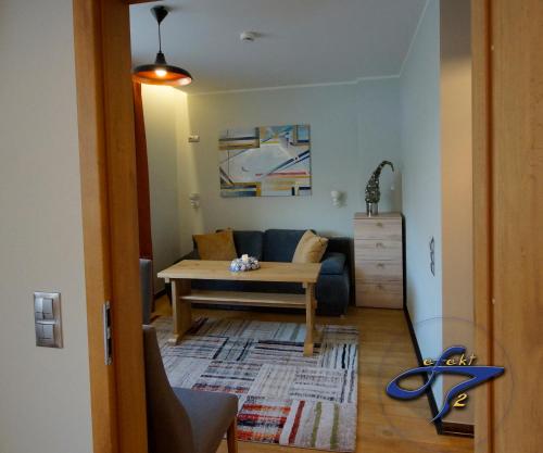 a living room with a couch and a table at Apartamenty Efekt 72 in Gdynia