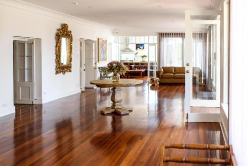 a living room with a table and a couch at Fairlawn Estate in Busselton
