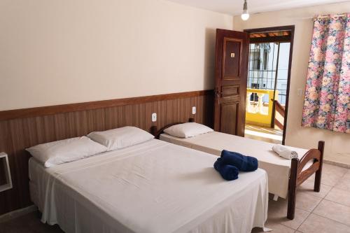 Een bed of bedden in een kamer bij Pé N'Areia