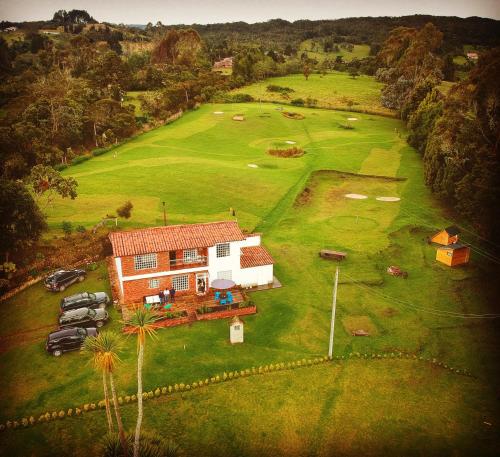 an aerial view of a house on a golf course at HOBU MONTAÑA in La Calera