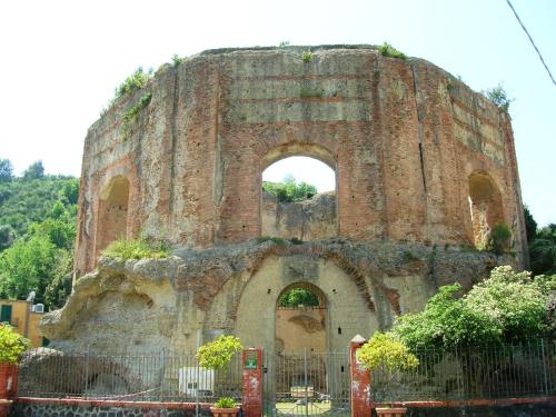 an old brick building with an arch in it at Domus Fortunae B&B in Bacoli