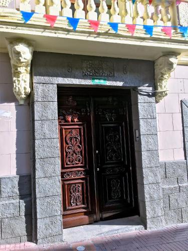 a large wooden door in a stone building at Hotel La Basílica Quito in Quito