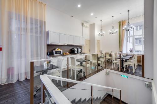 a kitchen and dining room with a table and chairs at Epigraph Hotel in Saint Petersburg