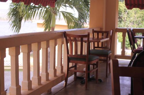 a row of chairs sitting on a balcony with a window at Parador Guánica 1929 in Guanica