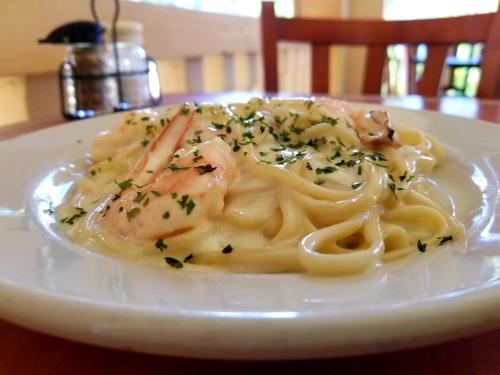 a plate of pasta with shrimp on a table at Parador Guánica 1929 in Guanica