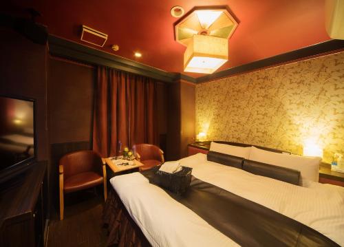 a hotel room with a bed and a table at Hotel Renaissance Sendai -Adult Only in Sendai