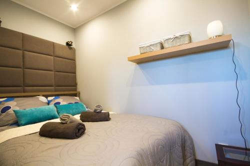a bedroom with a bed with two stuffed animals on it at Apartament Attico in Kowary