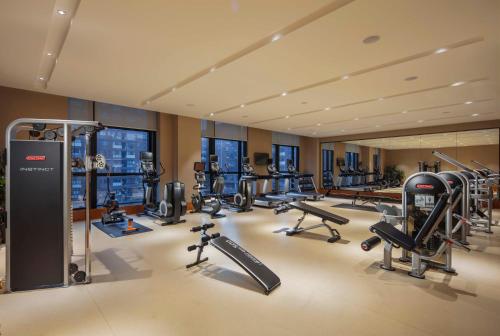 a gym with several treadmills and exercise bikes at Wyndham Shanghai Nanxiang in Jiading