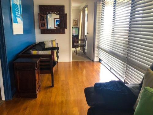 a living room with a couch and a table at Blue Ocean Haven - Expansive Ocean Views in this Classic Family Beach House in Peppermint Grove Beach in Capel