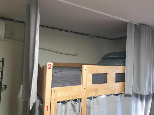 a bunk bed in a room with a window at Able Guesthouse Hongdae 2 in Seoul