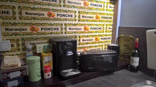 a counter with a coffee maker and a pay phone at Bambou & Olivier Chambres in Roubaix