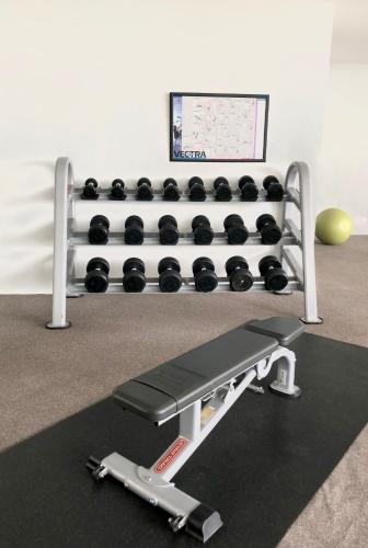 a gym with a rack of weights at Scientia Residences by Taslim Gading Serpong in Serpong