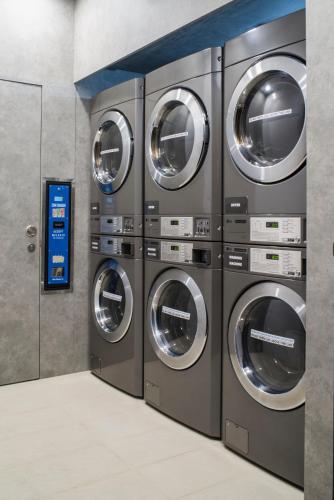 a row of washing machines in a laundromat at Mercure Singapore On Stevens in Singapore