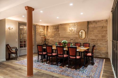 a dining room with a table and chairs at Hotel Ducs de Bourgogne in Paris