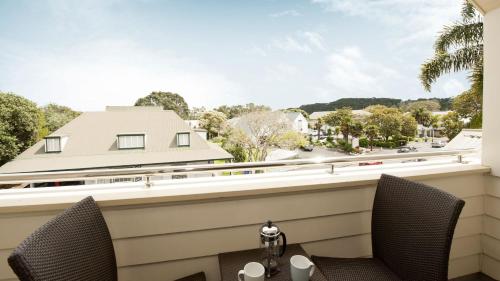 a view from the balcony of a house with a table and chairs at Hananui Lodge and Apartments in Russell