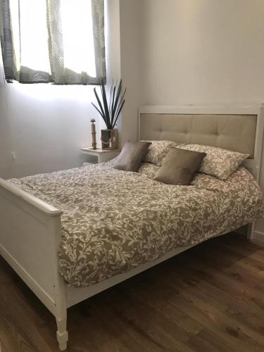 a bed with two pillows on it in a bedroom at Edera e Camelie in Pompei