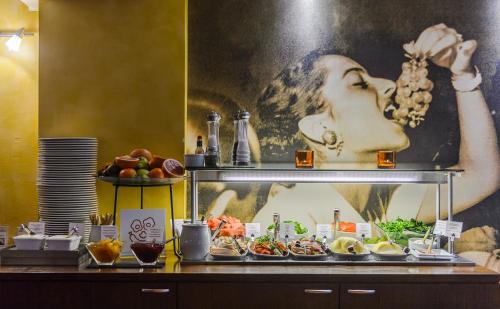 a buffet with a picture of a woman on the wall at Original Sokos Hotel Albert in Helsinki