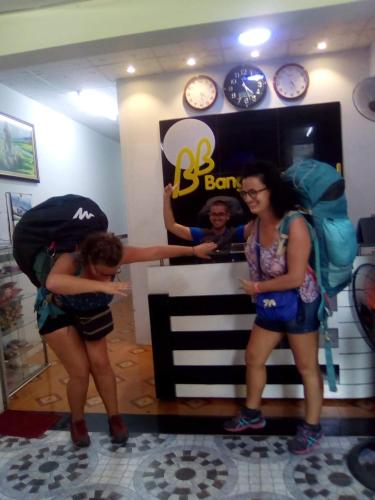 two girls standing in front of a barber shop at BangBang Motel in Can Tho