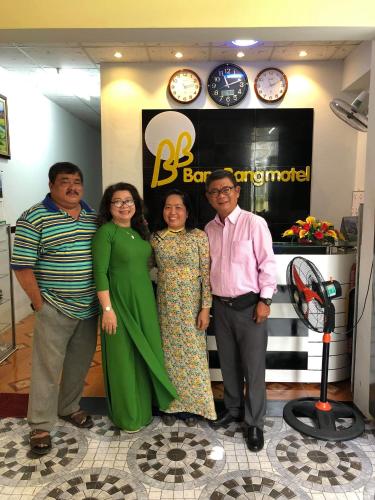 a group of people posing for a picture in a store at BangBang Motel in Can Tho