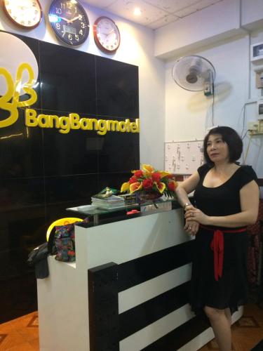a woman standing next to a counter in a store at BangBang Motel in Can Tho
