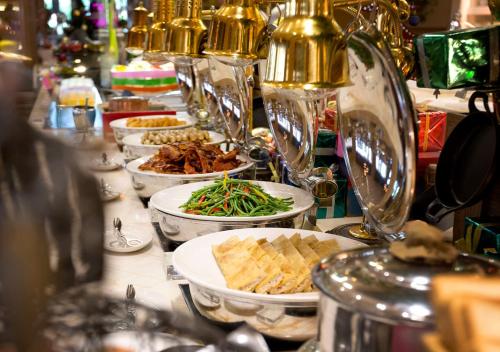 a buffet with plates of food on a table at Mulia Resort in Nusa Dua