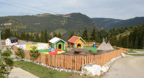 a childrens play park with a fence and a playground at Eko-FIS Vlašić in Vlasic