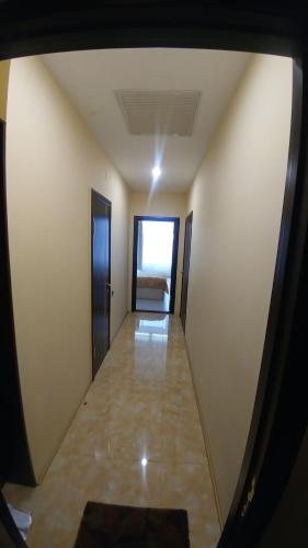 an empty hallway with a door and a room at Seven Eleven Most City Hotel&SKYTECH in Dnipro