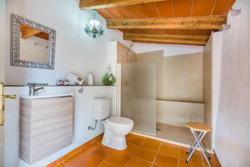 a bathroom with a toilet and a sink at Villa Can Pau By SunVillas Mallorca in Pollença